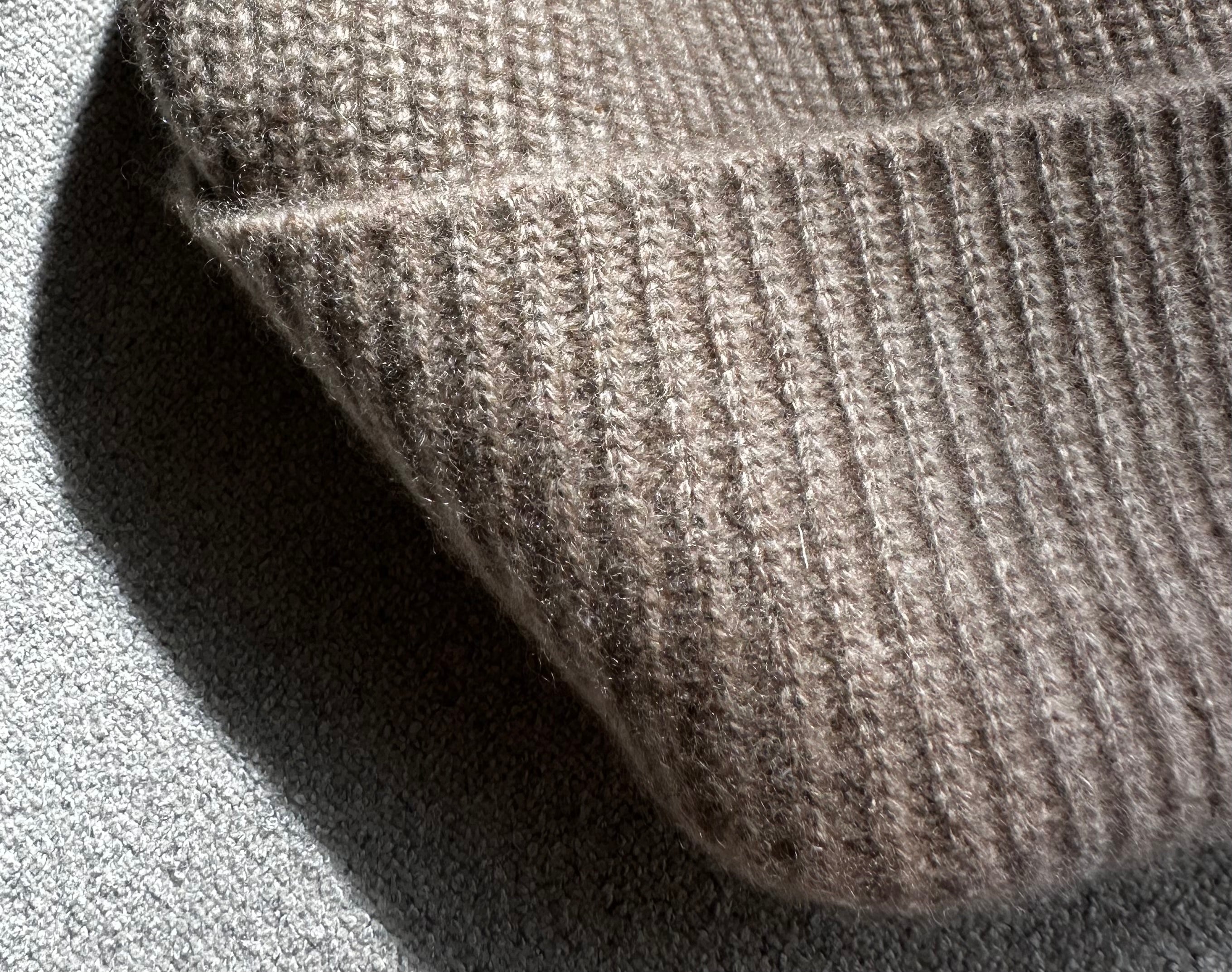 Detail of the undyed cashmere rib knit and folded cuff in Natural Beige