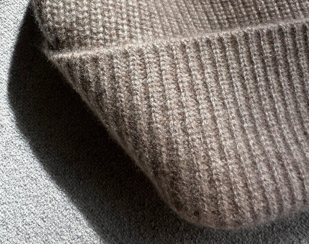 Detail of the undyed cashmere rib knit and folded cuff in Natural Beige