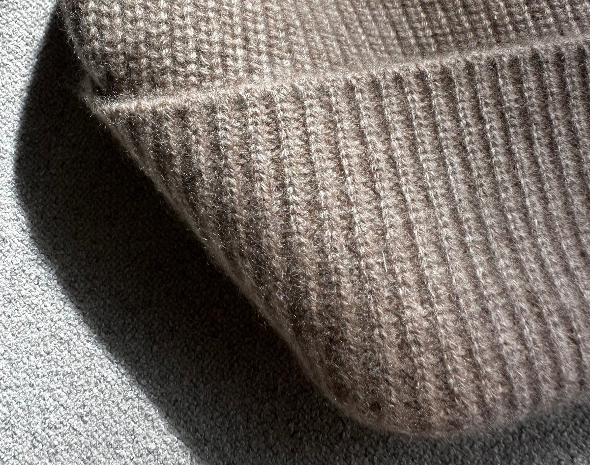 Detail of the undyed cashmere rib knit and folded cuff in Natural Beige